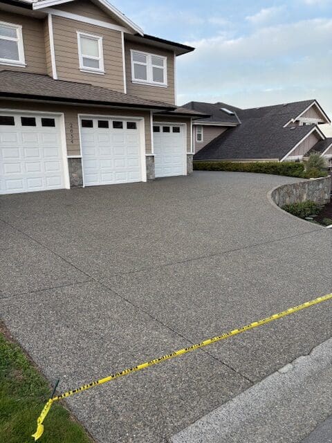 Protected exposed aggregate concrete in Victoria, BC, after pressure washing away dirt and grime.